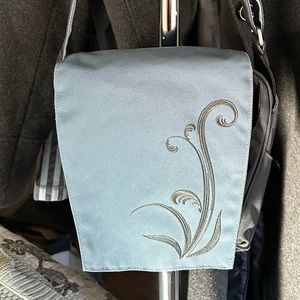 REI women’s crossbody bag, blue/black, magnetic closure. Like new condition.